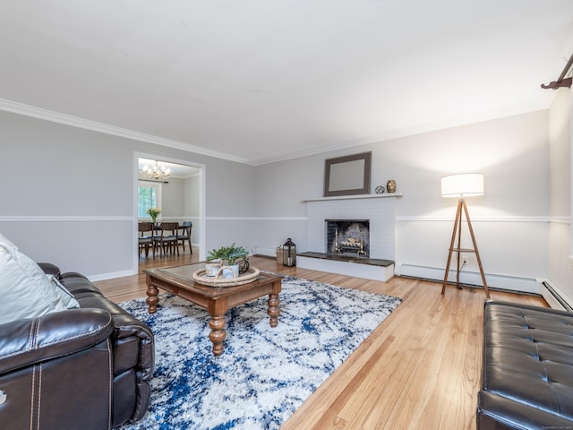 1 Blue Ridge Ln, Wilton, CT 06897 - living area with a chandelier, crown molding, a baseboard heating unit, a brick fireplace, and wood finished floors