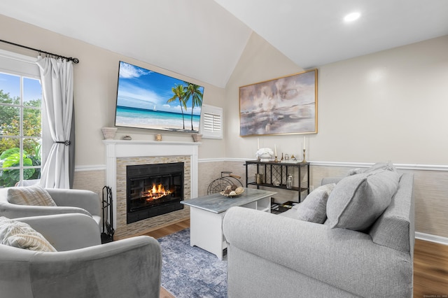 2122 Old Pond Ln Unit 2122, Norwich, CT 06360 - living room featuring wood finished floors, a fireplace, lofted ceiling, and a wainscoted wall