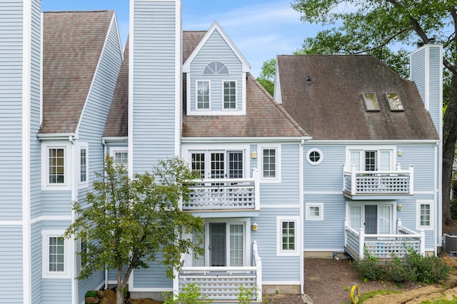 2122 Old Pond Ln Unit 2122, Norwich, CT 06360 - back of property featuring a chimney, a balcony, and a shingled roof