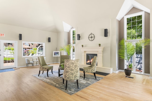 2122 Old Pond Ln Unit 2122, Norwich, CT 06360 - dining area featuring wood finished floors, vaulted ceiling, plenty of natural light, and a glass covered fireplace