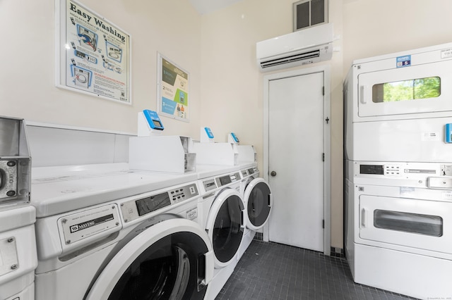 2122 Old Pond Ln Unit 2122, Norwich, CT 06360 - communal laundry room featuring stacked washing machine and dryer, washer and clothes dryer, dark tile patterned floors, and a wall unit AC