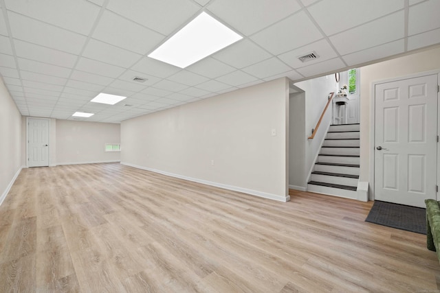 560 Laurel Hill Rd, Norwich, CT 06360 - below grade area featuring light wood finished floors, a drop ceiling, and stairs
