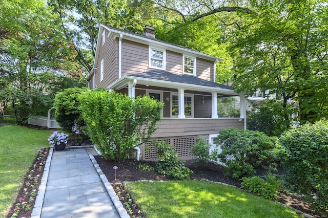 116 Knapp St, Stamford, CT 06907 - traditional style home featuring a front yard, a chimney, and covered porch
