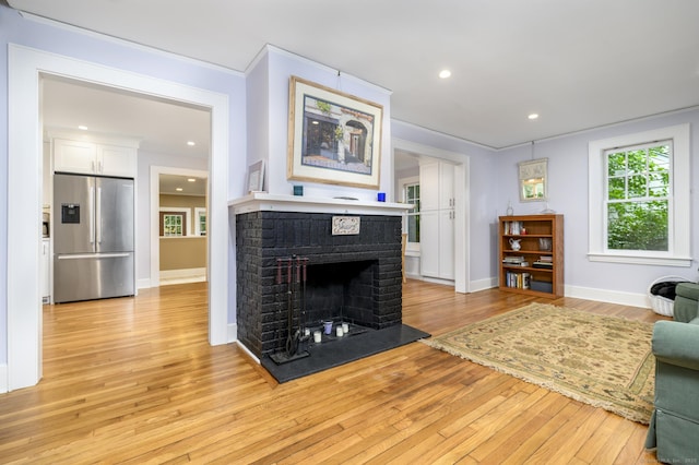 116 Knapp St, Stamford, CT 06907 - living area with light wood-type flooring, a fireplace, recessed lighting, and ornamental molding