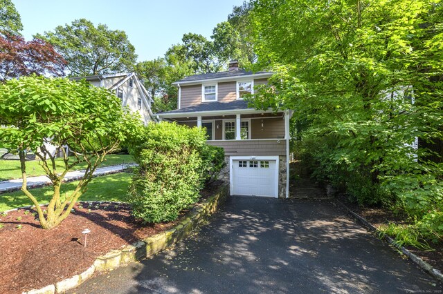 116 Knapp St, Stamford, CT 06907 - view of front of property with driveway, a chimney, an attached garage, and roof with shingles