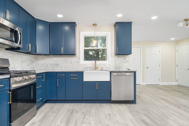 690 Bloomfield Ave, Windsor, CT 06095 - kitchen featuring appliances with stainless steel finishes, blue cabinetry, tasteful backsplash, light wood finished floors, and hanging light fixtures