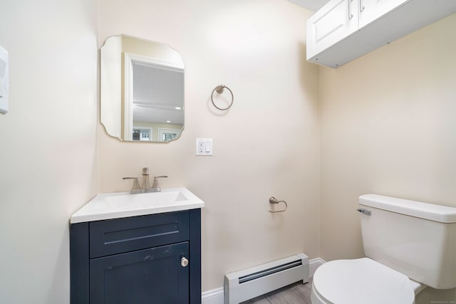 690 Bloomfield Ave, Windsor, CT 06095 - half bath with a baseboard radiator, vanity, and wood finished floors