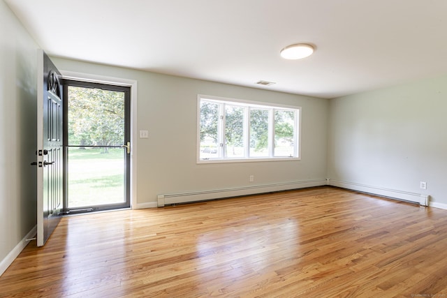 20 Sharon Dr, South Windsor, CT 06074 - empty room with a baseboard heating unit, plenty of natural light, and light wood-style floors