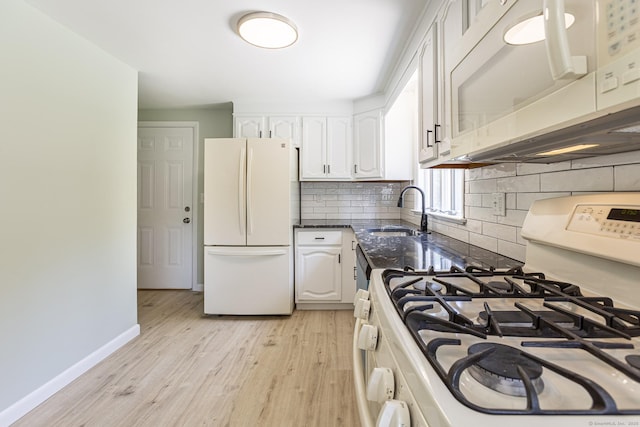 20 Sharon Dr, South Windsor, CT 06074 - kitchen featuring white appliances, white cabinetry, light wood-type flooring, tasteful backsplash, and dark stone counters