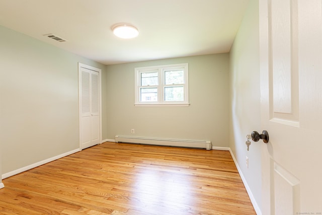 20 Sharon Dr, South Windsor, CT 06074 - empty room with a baseboard heating unit and light wood-type flooring