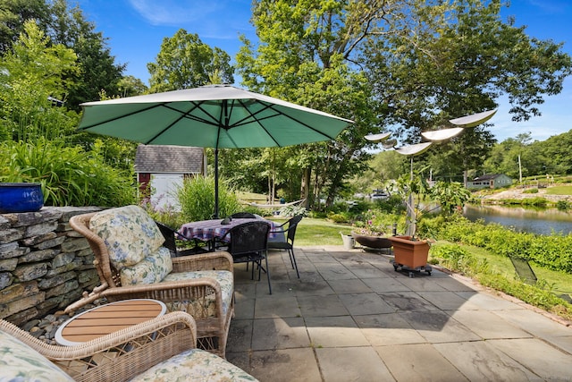 271 Haywardville Rd, East Haddam, CT 06415 - view of patio with outdoor dining area, a storage shed, and a water view