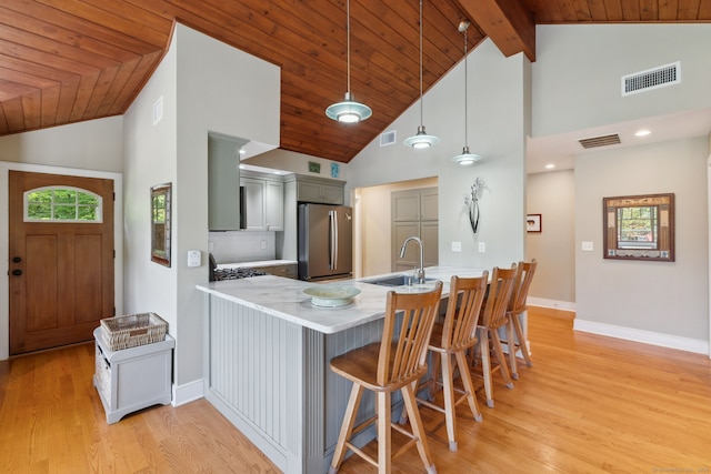 271 Haywardville Rd, East Haddam, CT 06415 - kitchen featuring freestanding refrigerator, a peninsula, high vaulted ceiling, light wood-style flooring, and light countertops