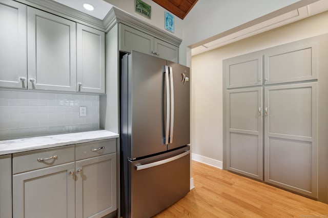271 Haywardville Rd, East Haddam, CT 06415 - kitchen with freestanding refrigerator, gray cabinets, backsplash, light wood-style flooring, and light stone counters