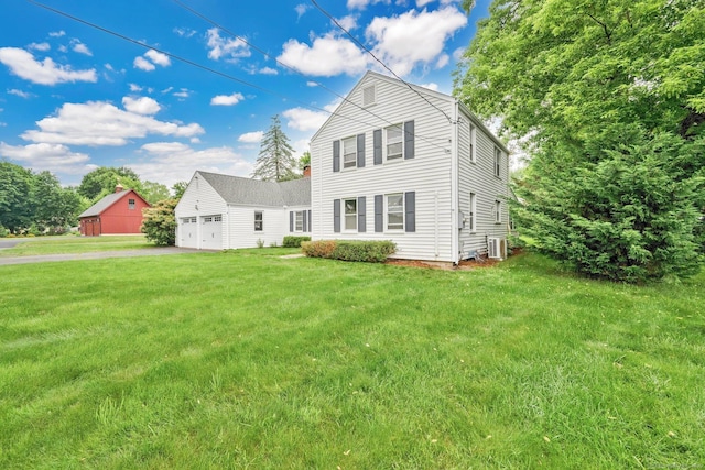 253 Gardner St, Manchester, CT 06040 - traditional-style house featuring a garage, asphalt driveway, and a front lawn