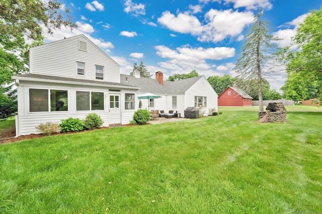 253 Gardner St, Manchester, CT 06040 - rear view of property featuring a shingled roof, a yard, a chimney, and a patio