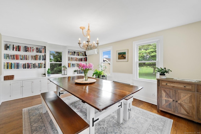 253 Gardner St, Manchester, CT 06040 - dining space with a chandelier, a wainscoted wall, dark wood-style flooring, and radiator heating unit