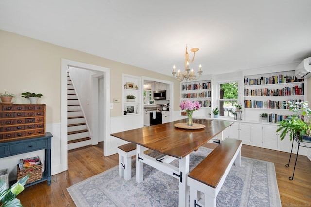 253 Gardner St, Manchester, CT 06040 - dining area featuring stairs, a chandelier, built in features, and wood finished floors