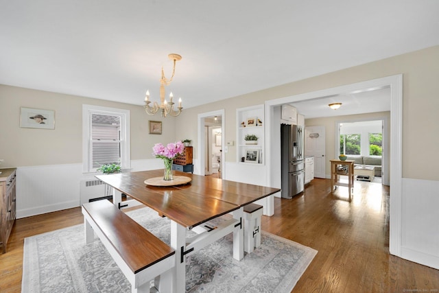 253 Gardner St, Manchester, CT 06040 - dining room featuring a chandelier, radiator heating unit, wainscoting, and dark wood-style floors