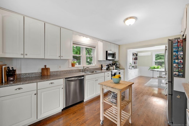 253 Gardner St, Manchester, CT 06040 - kitchen featuring stainless steel appliances, wood finished floors, and white cabinetry