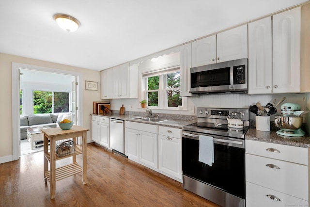 253 Gardner St, Manchester, CT 06040 - kitchen with appliances with stainless steel finishes, wood finished floors, and white cabinets