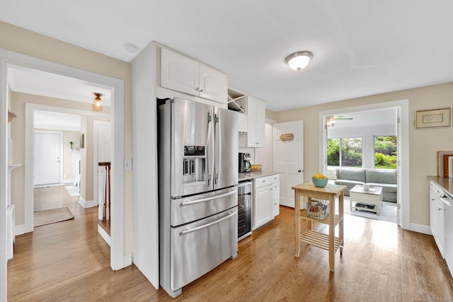 253 Gardner St, Manchester, CT 06040 - kitchen featuring stainless steel fridge, wine cooler, white cabinets, and light wood finished floors