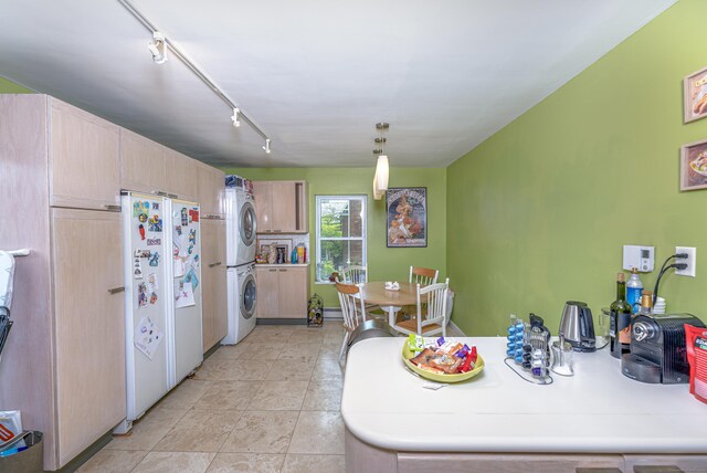 272 Saint John St, New Haven, CT 06511 - kitchen with stacked washer / drying machine, freestanding refrigerator, light brown cabinets, light tile patterned flooring, and pendant lighting