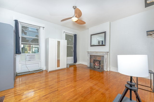 272 Saint John St, New Haven, CT 06511 - unfurnished living room featuring light wood-type flooring, a fireplace, ceiling fan, and cooling unit