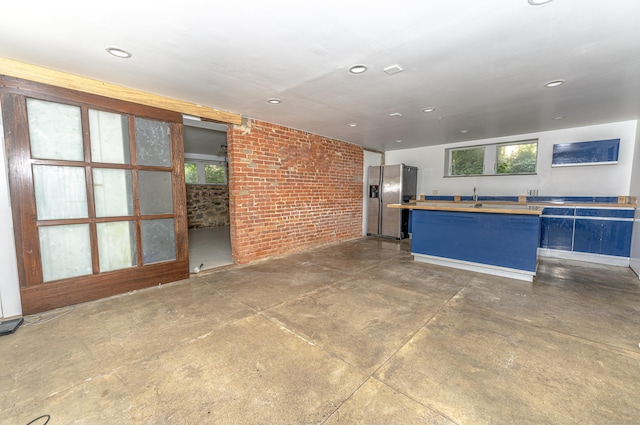 272 Saint John St, New Haven, CT 06511 - kitchen with stainless steel fridge, healthy amount of natural light, brick wall, concrete flooring, and recessed lighting