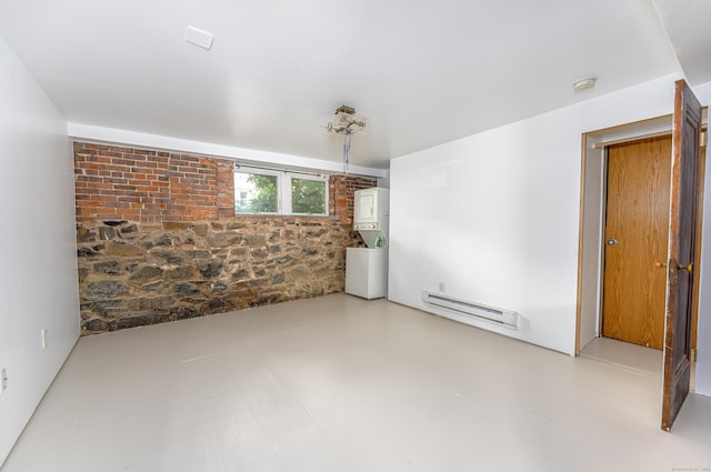 272 Saint John St, New Haven, CT 06511 - unfurnished room featuring a baseboard radiator, stacked washing machine and dryer, and a smoke detector