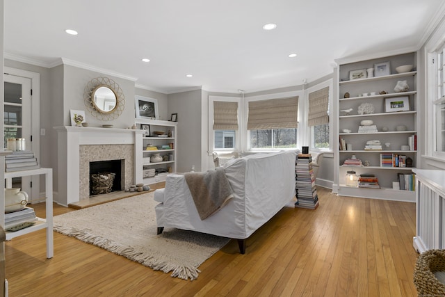 634 Nod Hill Rd, Wilton, CT 06897 - living room with light wood-type flooring, a fireplace with raised hearth, crown molding, recessed lighting, and built in features