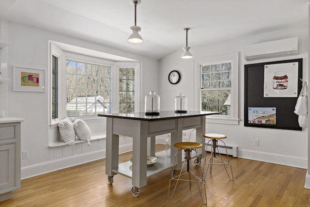 634 Nod Hill Rd, Wilton, CT 06897 - kitchen with a wall unit AC, light wood-style flooring, a baseboard radiator, and pendant lighting