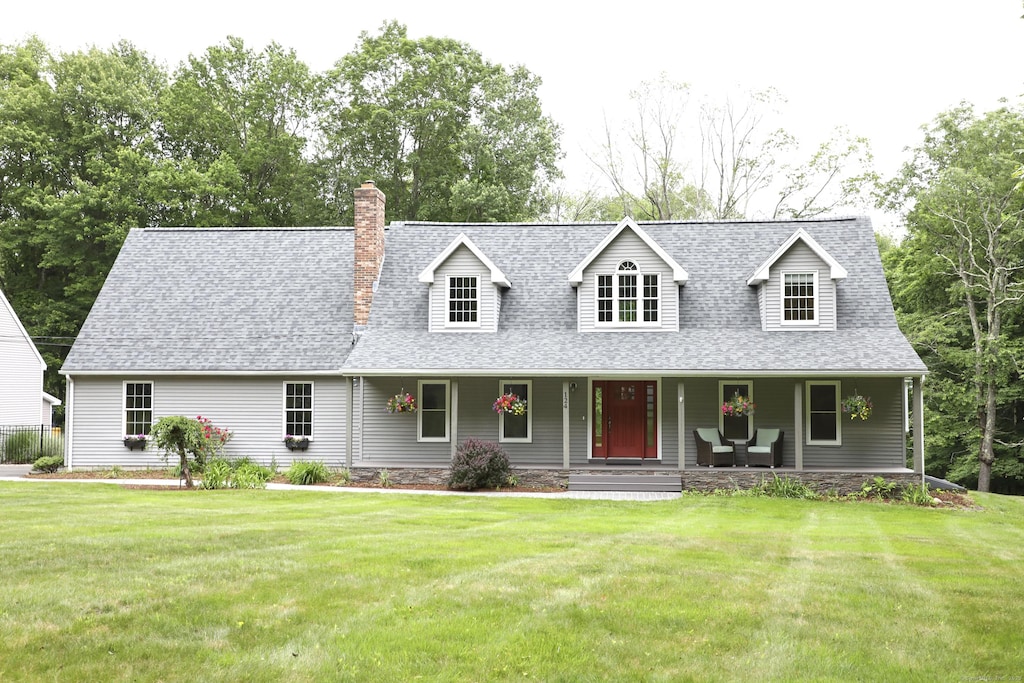 124 Tartia Rd, East Hampton, CT 06424 - cape cod home with a front yard, a porch, a shingled roof, and a chimney