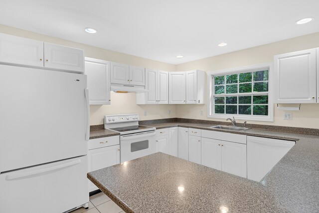 153 Louis Hill Rd Unit 153, Newtown, CT 06482 - kitchen featuring white appliances, under cabinet range hood, dark countertops, white cabinetry, and a peninsula