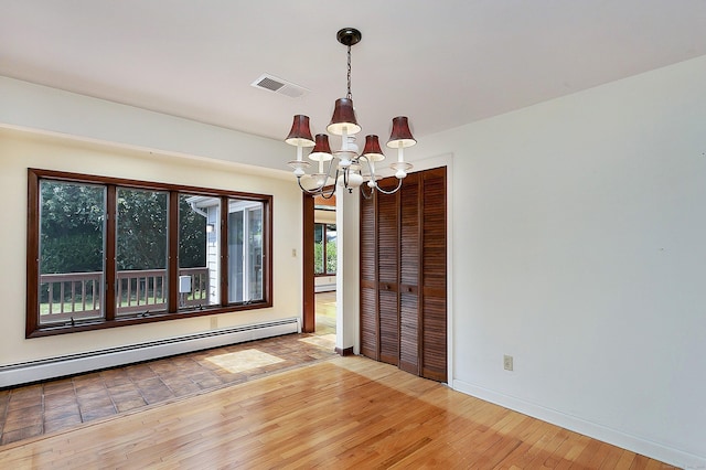 134 Millard St, Fairfield, CT 06824 - empty room with a chandelier, a baseboard heating unit, and light wood-style flooring