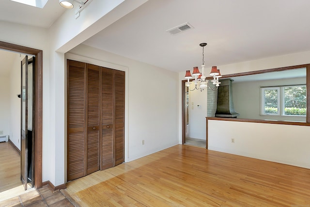 134 Millard St, Fairfield, CT 06824 - unfurnished dining area with a chandelier and light wood-style floors