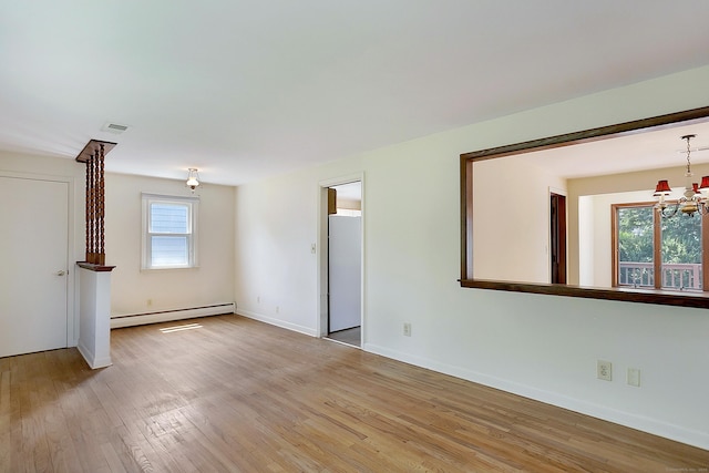 134 Millard St, Fairfield, CT 06824 - unfurnished living room with a baseboard heating unit, light wood-style floors, and a chandelier
