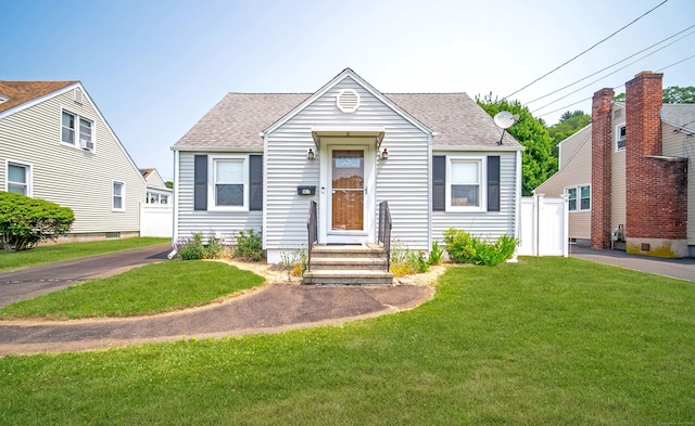 103 Saltonstall Pkwy, East Haven, CT 06512 - view of front of home featuring a front lawn, roof with shingles, and entry steps