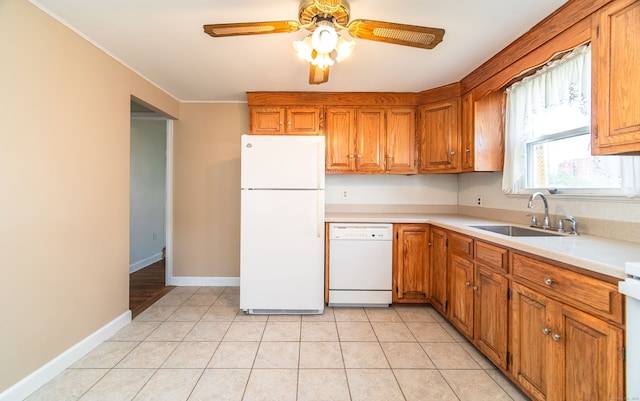103 Saltonstall Pkwy, East Haven, CT 06512 - kitchen with white appliances, brown cabinetry, ceiling fan, light countertops, and light tile patterned floors