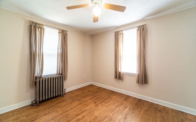103 Saltonstall Pkwy, East Haven, CT 06512 - spare room featuring radiator, plenty of natural light, wood finished floors, ceiling fan, and ornamental molding