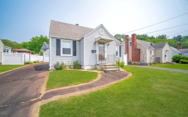 103 Saltonstall Pkwy, East Haven, CT 06512 - view of front of property featuring a shingled roof and driveway