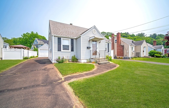 103 Saltonstall Pkwy, East Haven, CT 06512 - view of front of property with a garage, a shingled roof, and an outdoor structure