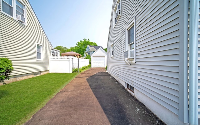 103 Saltonstall Pkwy, East Haven, CT 06512 - view of yard with driveway, a detached garage, an outdoor structure, and cooling unit
