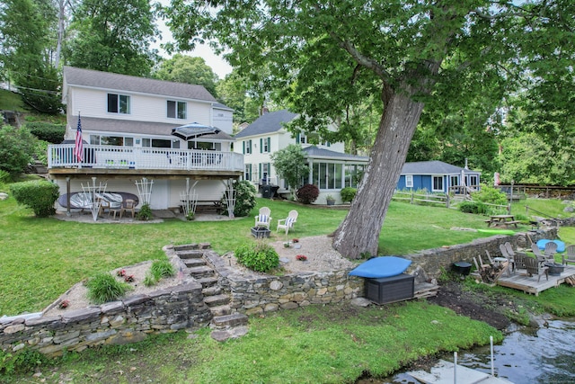 81 Standish Rd, Coventry, CT 06238 - rear view of house featuring a wooden deck, an outdoor fire pit, a yard, and a patio area