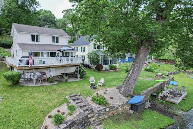 81 Standish Rd, Coventry, CT 06238 - back of property featuring a wooden deck, a yard, roof with shingles, and a patio