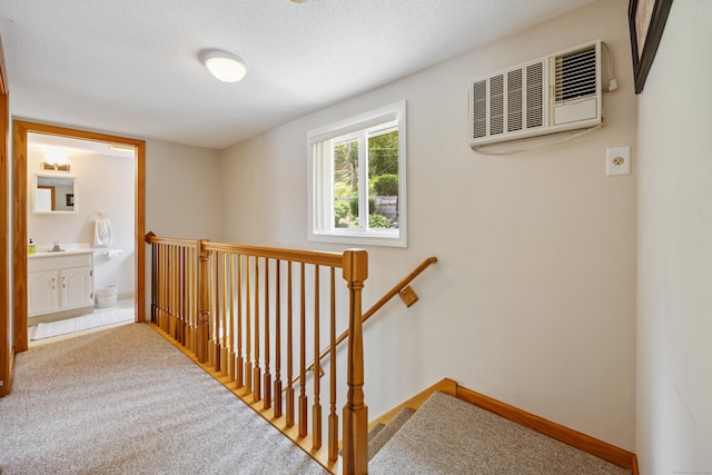81 Standish Rd, Coventry, CT 06238 - hall featuring an upstairs landing, a wall mounted AC, and carpet floors