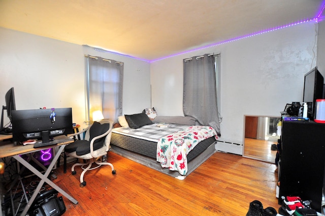 9 Eleanor Rd, Enfield, CT 06082 - bedroom with a baseboard heating unit, a desk, and wood finished floors
