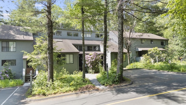 67 Woodside Cir Unit 67, Torrington, CT 06790 - view of front facade featuring roof with shingles and uncovered parking