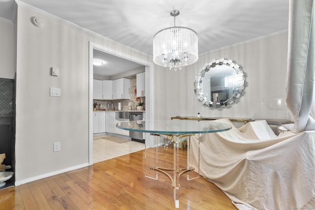 67 Woodside Cir Unit 67, Torrington, CT 06790 - dining space featuring light wood-style flooring, crown molding, and a chandelier