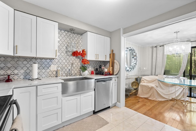 67 Woodside Cir Unit 67, Torrington, CT 06790 - kitchen featuring appliances with stainless steel finishes, light countertops, a chandelier, and light tile patterned floors