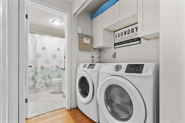 67 Woodside Cir Unit 67, Torrington, CT 06790 - washroom featuring washing machine and clothes dryer, cabinet space, and light wood finished floors